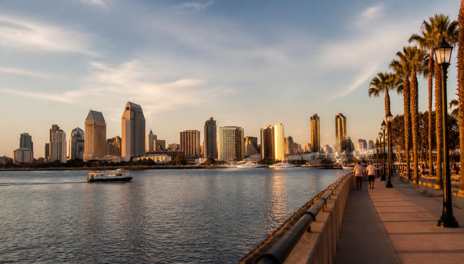 San Diego Bay and downtown skyline glowing at golden hour with a ferry crossing